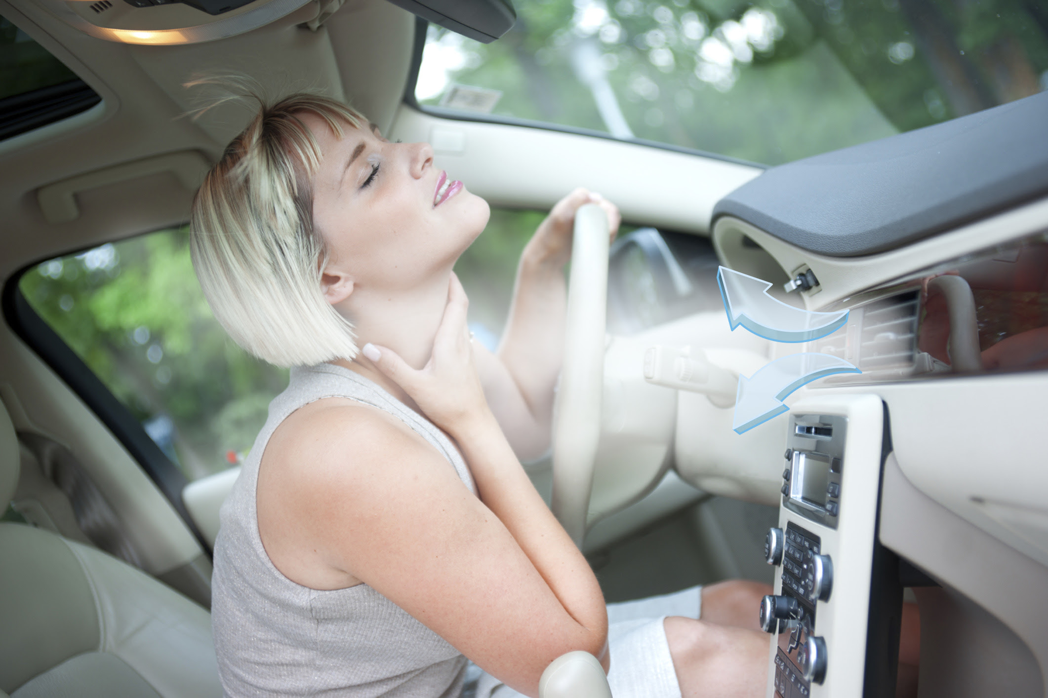 woman driver cooling herself with blowing from air conditioner in the car